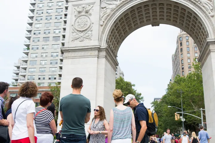 a group of people standing in front of Washington Square Park