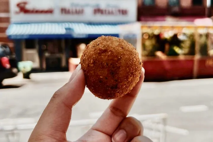 a hand holding an ice cream cone