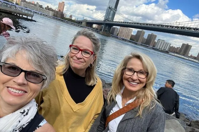 Marsha Collier et al. standing next to a body of water