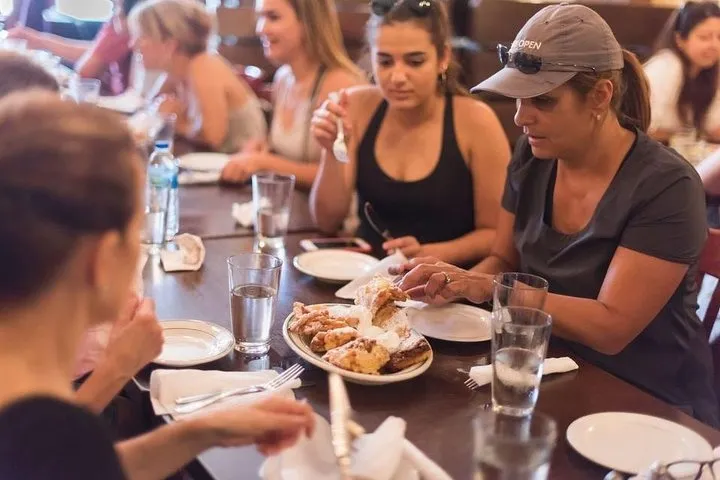 a group of people sitting at a table eating food