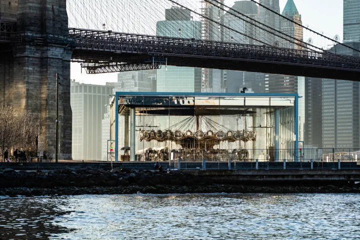 a train crossing a bridge over a body of water
