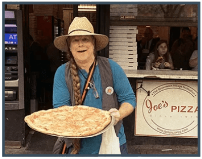 a person standing in front of a pizza