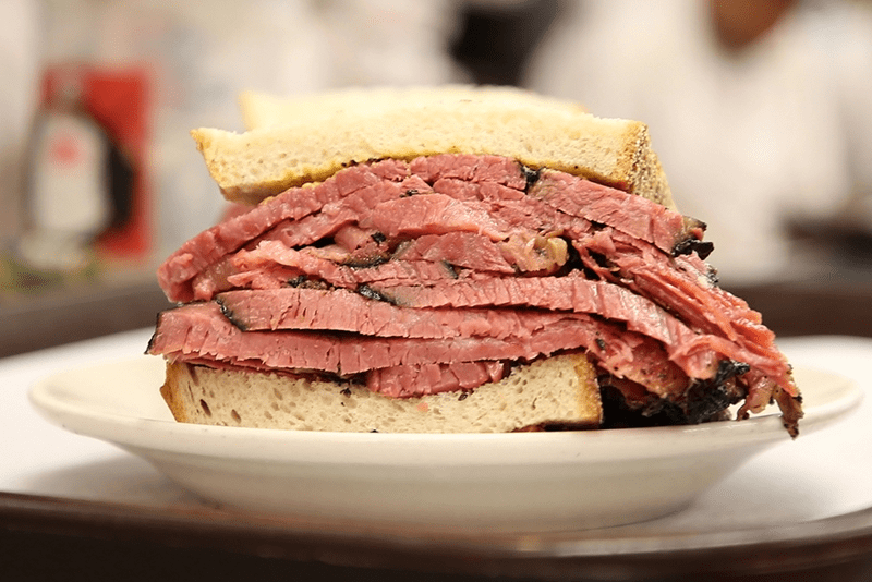 the-5-best-jewish-delis-in-nyc-for-an-unforgettable a close up of a sandwich on a plate