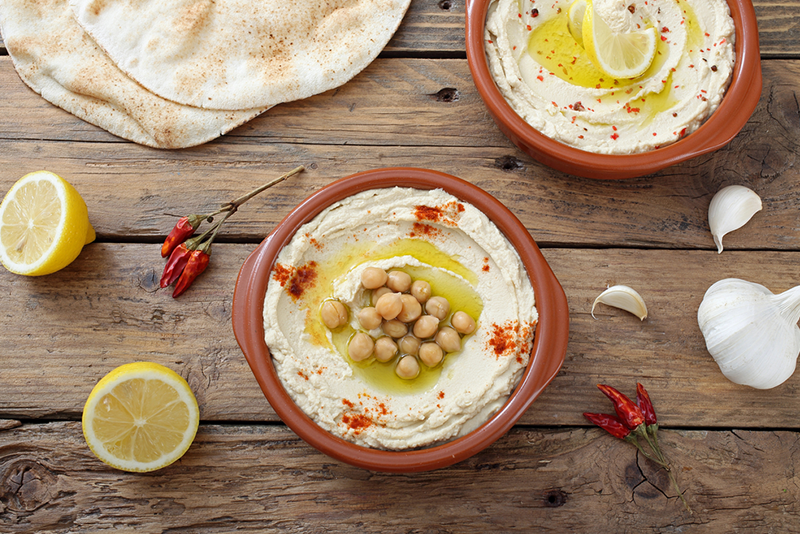 top-6-middle-eastern-spots-for-a-culinary-tour a plate of food sitting on top of a wooden cutting board
