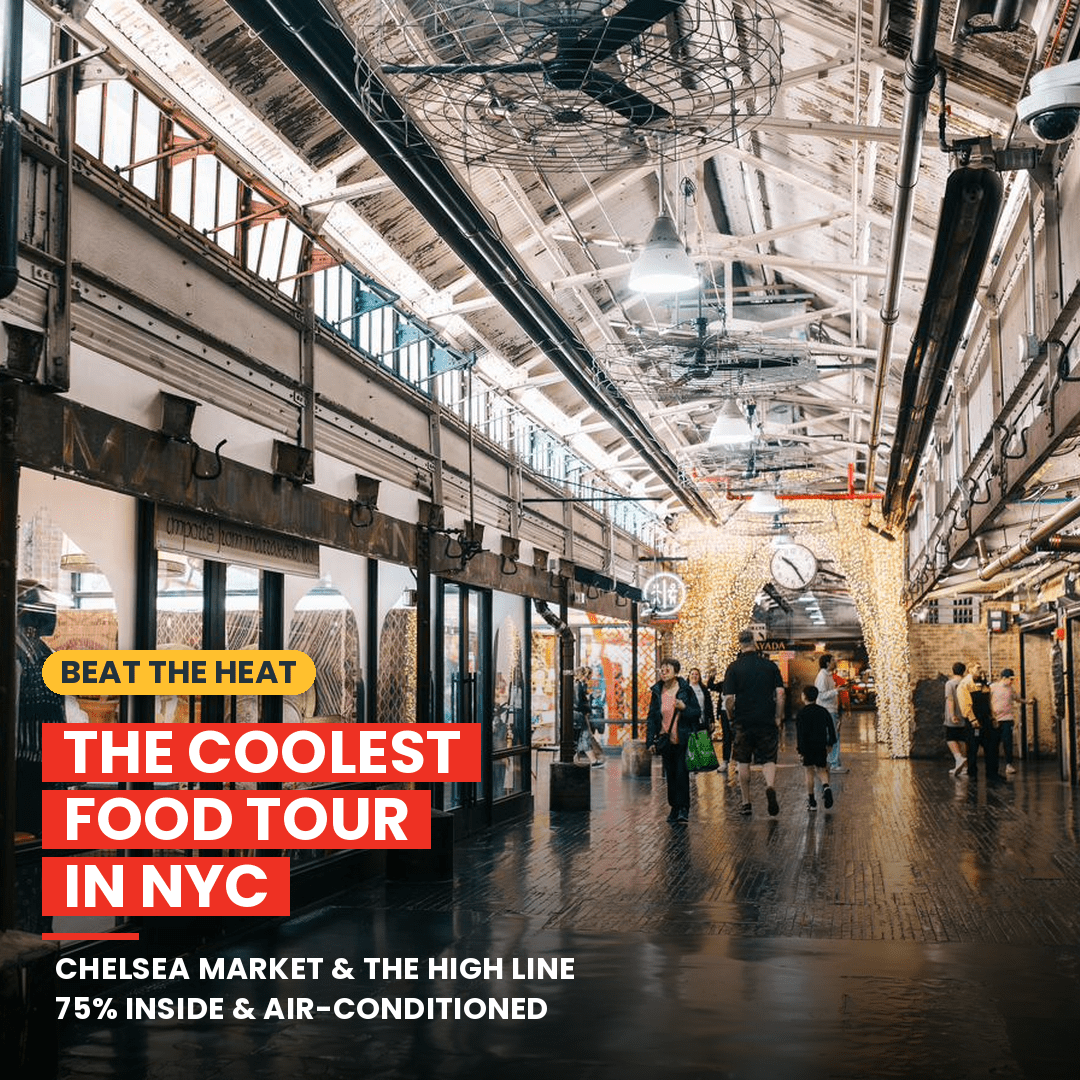 Industrial indoor market with people walking under a glass roof.